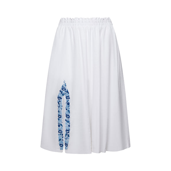 long white skirt with blue floral accents