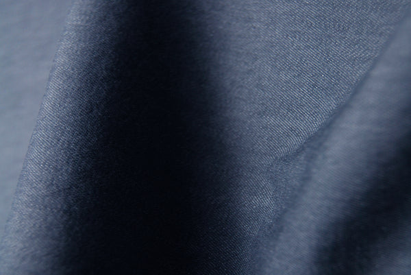 A close up swatch of blue denim fabric texture