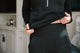 Person wearing a black outfit with a blurred indoor background