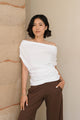 woman wearing white shirt with brown pants