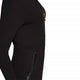 closeup of black colored jumpsuit with gold zipper, from side angle