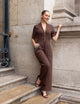 woman wearing brown shirt and gold zipper and brown pants