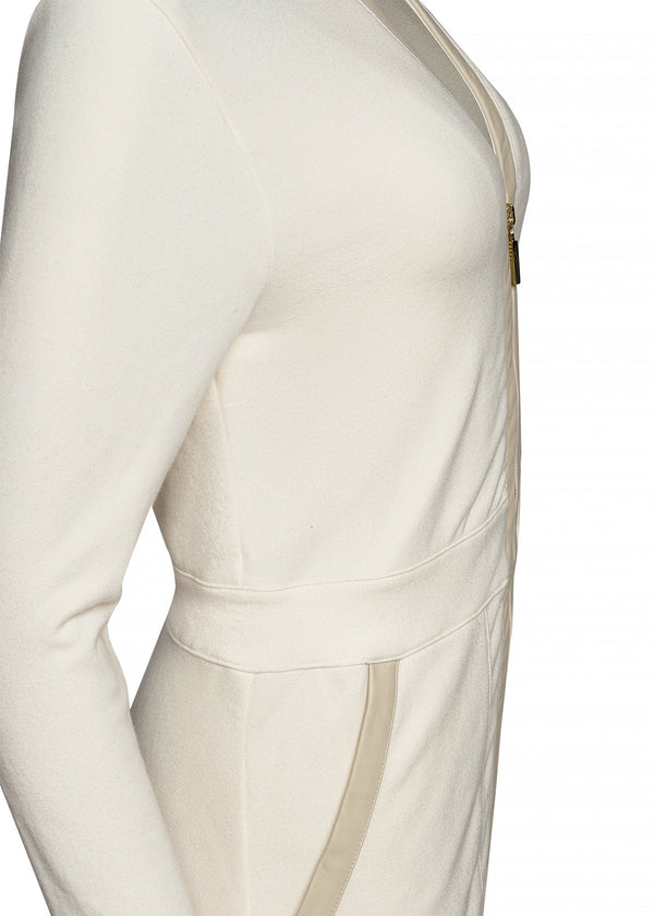 closeup of cream colored jumpsuit with gold zipper, from side angle