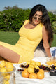 rib knit dress in yellow, lemons, woman with brunette hair wearing trendy glasses