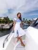 woman wearing white dress with floral accents