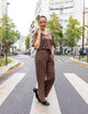 woman wearing brown shirt, and brown pants
