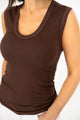 woman wearing brown tank top side view
