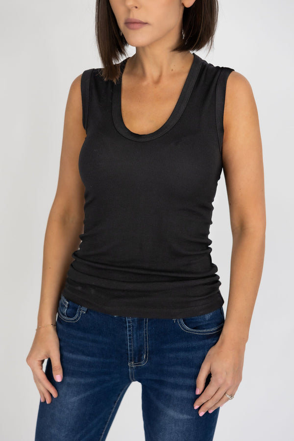 woman wearing a black tank top with jeans