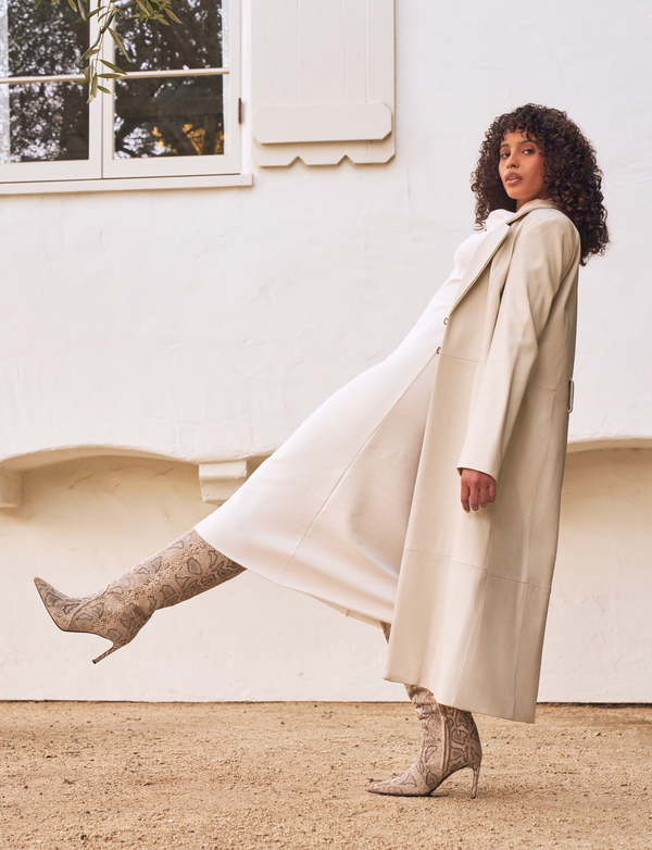 woman wearing long white dress, with white overcoat