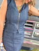 woman wearing denim vest with gold zipper and denim skirt