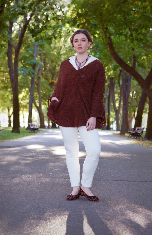 woman wearing tan shirt, tan pants, and brown covering