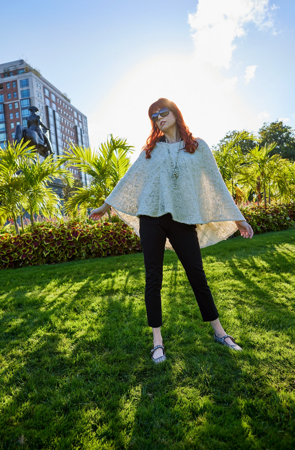 woman wearing black shirt, black pants and tan covering