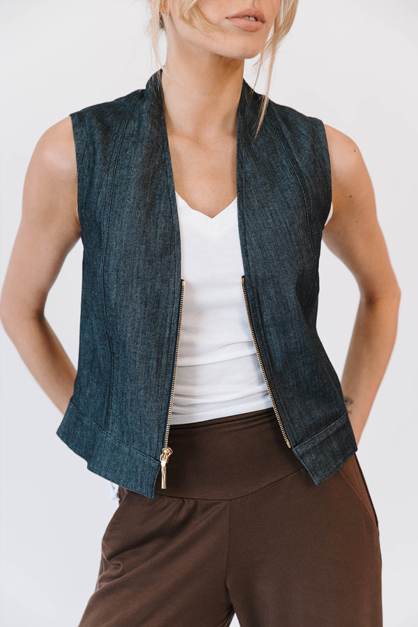 woman wearing white shirt with denim vest with brown pants