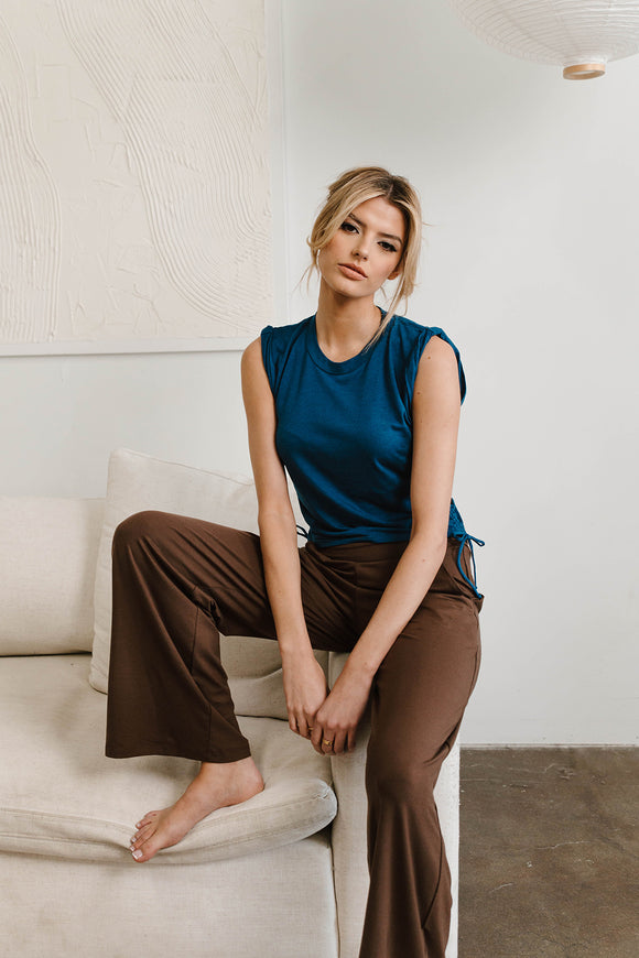 woman wearing blue shirt with brown pants