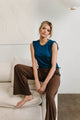 woman wearing blue shirt with brown pants