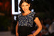 woman wearing black shirt with frill sleeves and floral pattern on front