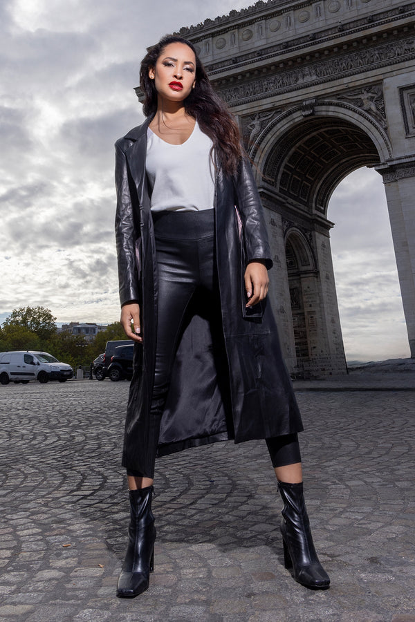 woman wearing black trench coat with a white shirt and leather pants