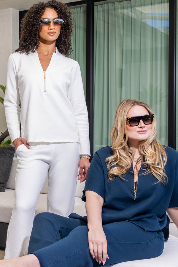 two women modeling the same outfit, one in white and one in blue