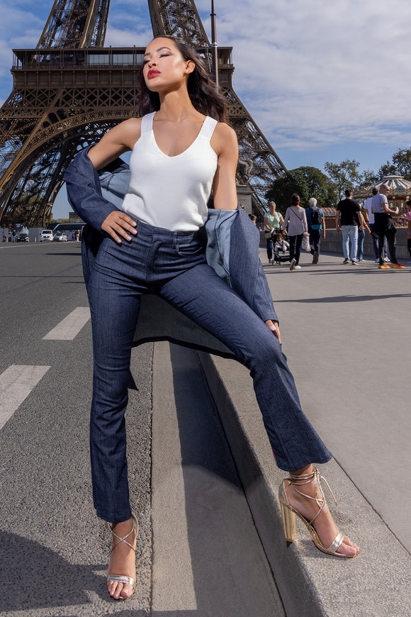 woman wearing navy blue denim pants, white wank top and denim overcoat