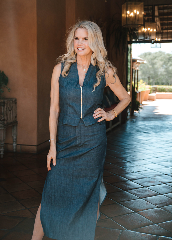 woman wearing blue denim tank top with gold zipper, and long denim skirt