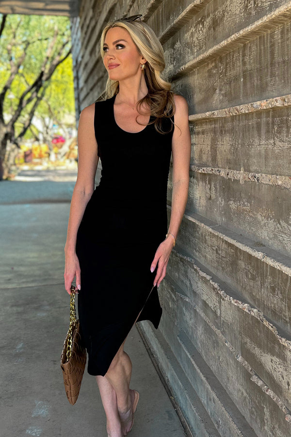 woman wearing long black dress with sunglasses