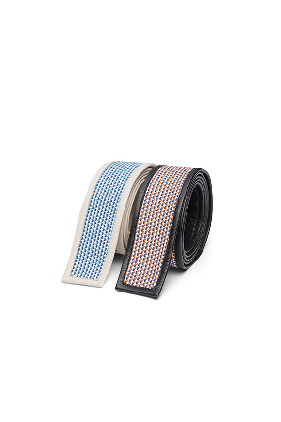 two belts, one white with blue patterned inside, other black with red and blue patterned inside