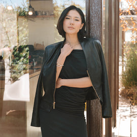 Woman in black outfit with leather jacket