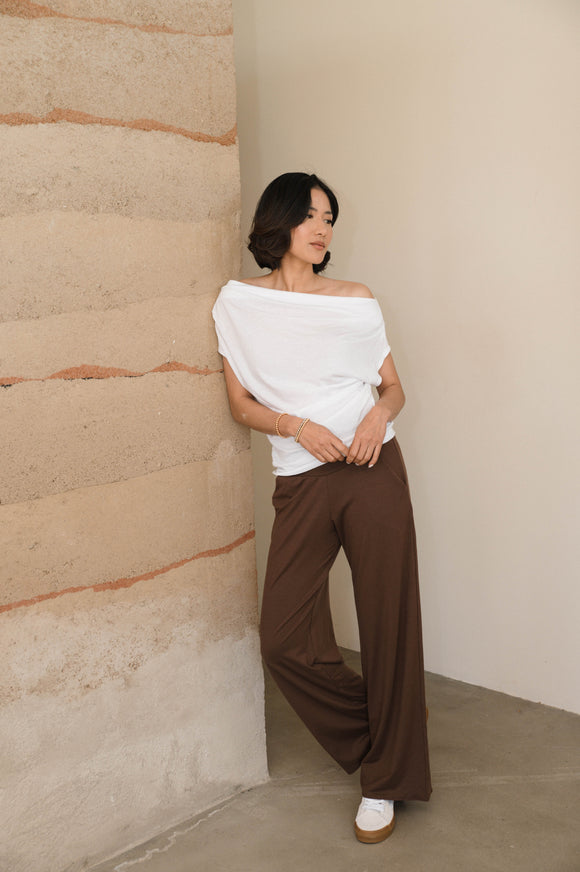 woman wearing white shirt and brown pants